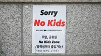 Foto yang diambil pada 20 Juli 2023 ini menunjukkan tanda 'No Kids Zone' di pintu masuk sebuah kafe di Seoul. Di negara dengan tingkat kelahiran terendah di dunia, munculnya semakin banyak fasilitas yang melarang anak-anak, seperti kafe, perpustakaan, dan galeri seni, membuat marah para orangtua, seperti anggota parlemen Korea Selatan Yong Hye In. (Yelim LEE/AFP)