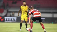 Pemain Persija Jakarta, Dony Tri Pamungkas (kiri) mencoba melewati pemain Madura United pada lanjutan BRI Super League 2025/2026 di Stadion Gelora Ratu Pamelingan, Jumat (24/10/2025) malam WIB. (Bola.com/Abdul Aziz).