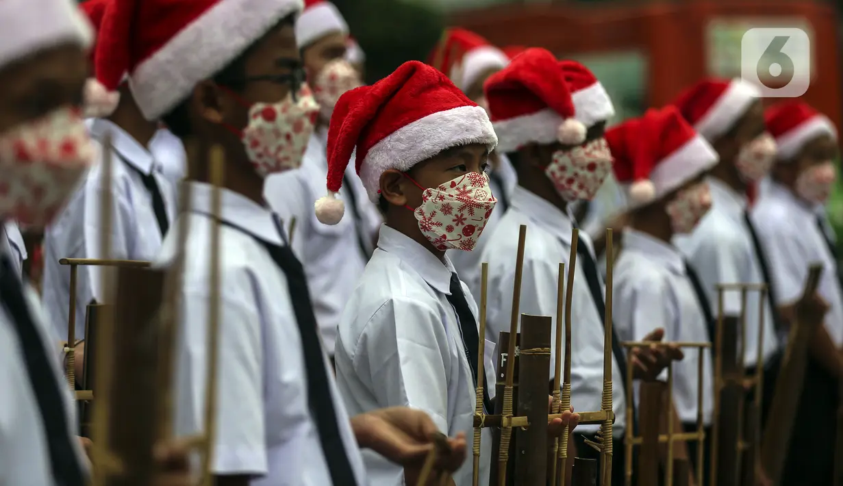 Para peserta bermain angklung saat acara Christmas in Jakarta di Bundaran Hotel Indonesia, Jakarta, Selasa (21/12/2021). Pemerintah Provinsi DKI Jakarta menggelar Christmas in Jakarta dalam rangka menyambut Natal 2021. (Liputan6.com/Johan Tallo)