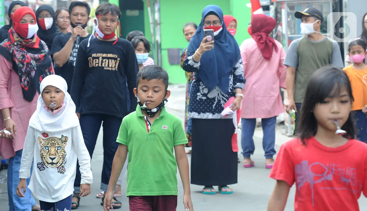 Anak-anak mengikuti lomba membawa kelereng saat acara kegiatan tujuh belas Agustus di Cinere, Depok, Senin (17/8/2020). Warga di sejumlah kampung di wilayah Jabodetabek tetap melakukan beragam kegiatan lomba memperingati HUT ke-75 RI dengan menerapkan protokol kesehatan. (merdeka.com/Arie Basuki)