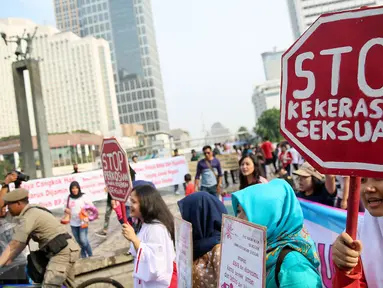Aktivis wanita dari Jaringan Muda menggelar aksi Stop Kekerasan Seksual saat Car Free Day di Bundaran HI, Jakarta, Minggu (6/12/2015). Dalam aksinya mereka menolak kekerasan seksual dan stop perkosaan. (Liputan6.com/Faizal Fanani)