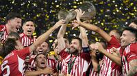 Selebrasi para pemain Olympiakos, Kostas Fortounis (tengah) dkk dengan trofi Europa Conference League 2023/2024 setelah mengalahkan Fiorentina 1-0 pada laga final di OPAP Arena, Athena, Yunani, Rabu (29/5/2024). (AP Photo/Petros Giannakouris)