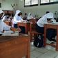 Pelajar SMP Negeri 1 Tambun Selatan, Bekasi mengikuti Pembelajaran Tatap Muka (PTM) terbatas dengan kapasitas 50 persen. (Liputan6.com/Bam Sinulingga)