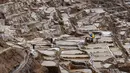 Pekerja beraktivitas di tambak garam di Maras, Peru, 29 April 2019. Tambak garam ini sudah digunakan sejak zaman pra-Inca. (Pablo PORCIUNCULA BRUNE/AFP)