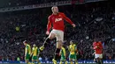 Penyerang Manchester United, Wayne Rooney melompat merayakan golnya ke gawang Norwich City di laga lanjutan Liga Primer Inggris di stadion Old Trafford (27/4/2014). (REUTERS/Nigel Roddis)