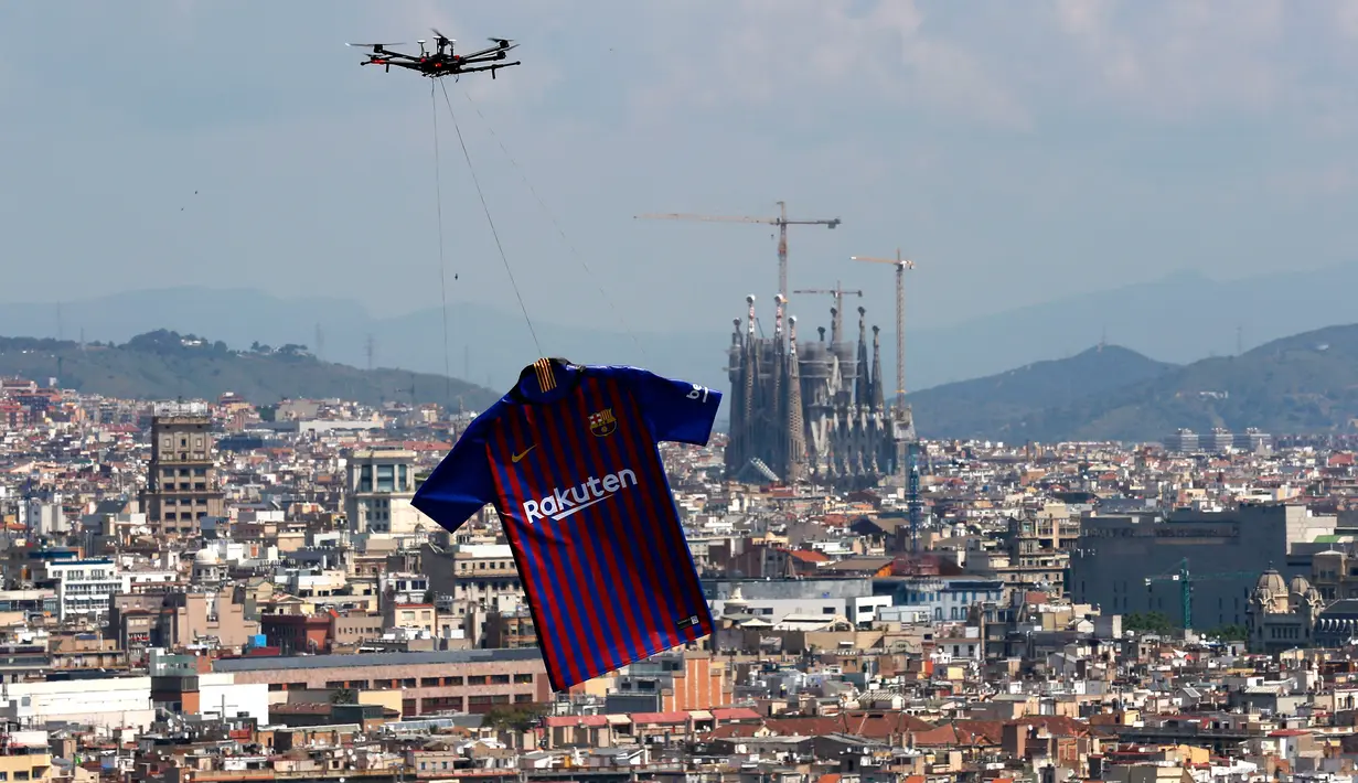 Barcelona menggunakan drone menerbangkan jersey terbarunya untuk musim 2018/2019 saat diperkenalkan di Montjuic Swimming Pool, 19 Mei 2018. Launching seragam kali ini  terbilang cukup mencolok dan berbeda dari biasanya. (AP/Manu Fernandez)