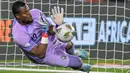 Kiper Nigeria, Stanley Nwabali, berhasil menghalau bola tendangan penalti pemain Afrika Selatan pada laga semifinal di Stade de la Paix, Kamis (8/2/2024). Nigeria melaju ke partai final setelah menang adu penalti dengan skor 4-2. (AFP/Issouf Sanogo)