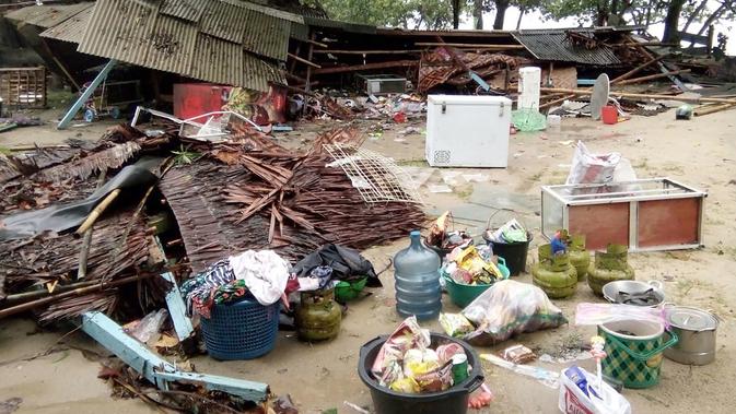 Sejumlah kebutuhan terlihat dekat sebuah rumah yang rusak setelah tsunami menerjang Pantai Carita, di perairan Banten, Minggu (23/12). Data sementara jumlah korban dari bencana tsunami di Selat Sunda tercatat 584 orang luka-luka. (SEMI / AFP)