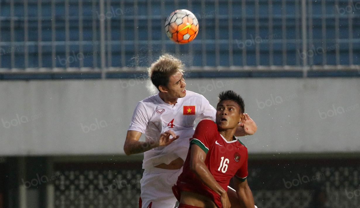 Aksi Fachrudin (kanan) menghadang pemain Vietnam pada laga uji coba di Stadion Maguwoharjo, Minggu (09/10/2016). (Bola.com/Nicklas Hanoatubun)