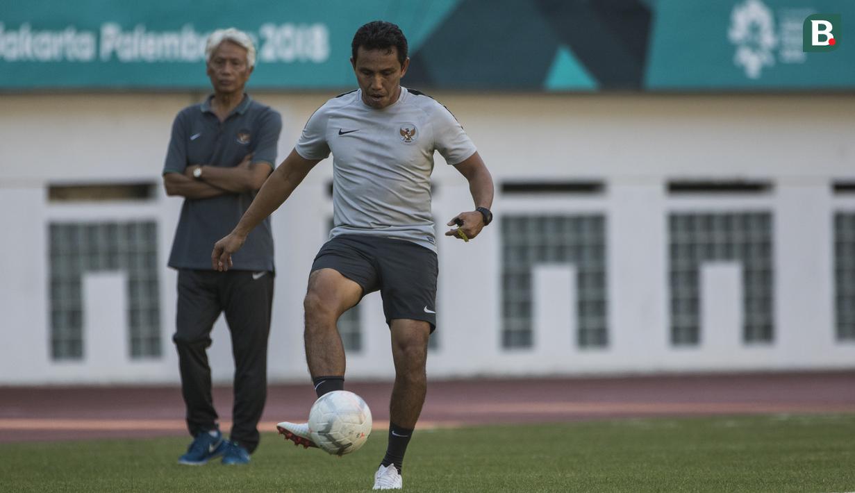 Pelatih Timnas Indonesia, Bima Sakti, mengontrol bola saat memimpin latihan di Stadion Wibawa Mukti, Jawa Barat, Senin (10/9/2018). Latihan ini persiapan jelang laga uji coba melawan Mauritius. (Bola.com/Vitalis Trisna)