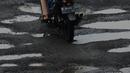 Pengendara sepeda motor menghindari jalan yang ruas saat melintasi ruas Jalan Lapangan Ros, Tebet, Jakarta, Sabtu (11/5/2019). Jalan-jalan berlubang yang terisi air tersebut dapat mengakibatkan kecelakaan bagi pengendara kendaraan bermotor. (merdeka.com/Imam Buhori)