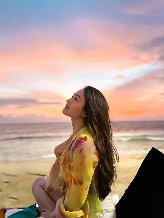 Blus sifon nuansa cerah tampak membaur sempurna dengan latar sunset. [@natashawilona12].