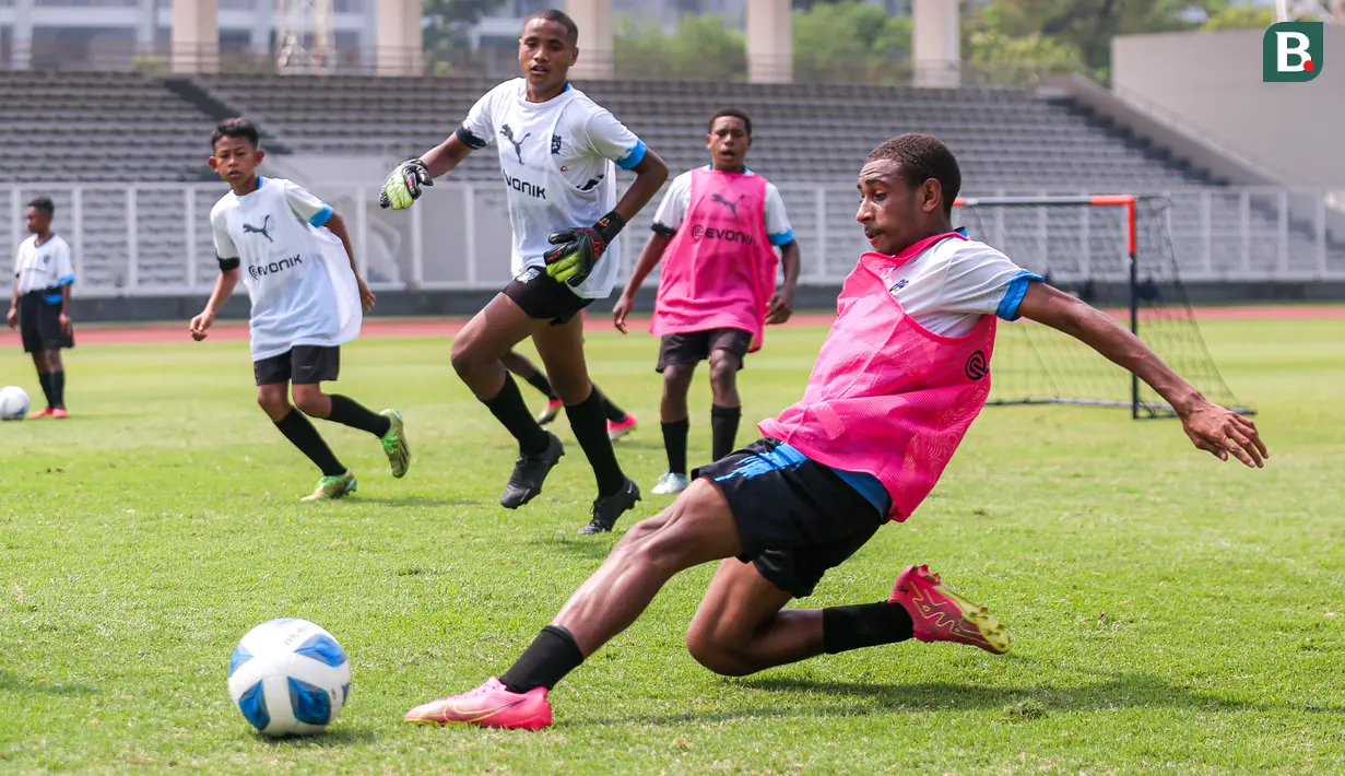 Seorang siswa Papua Football Academy mengejar bola saat coaching clinic bersama tiga legenda Borussia Dortmund di Stadion Madya, Senayan, Jakarta, Jumat (08/09/2023). (Bola.com/Bagaskara Lazuardi)