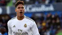 Bek Real Madrid, Raphael Varane, merayakan gol yang dicetaknya ke gawang Getafe pada laga La Liga Spanyol di Stadion Col Alfonso Perez, Getafe, Sabtu (4/1). Getafe kalah 0-3 dari Madrid. (AFP/Oscar Del Pozo)