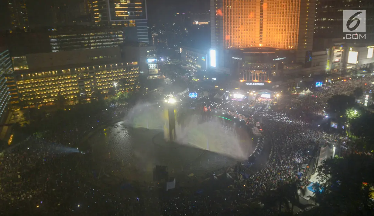 Ribuan warga memadati panggung hiburan pada malam puncak peringatan HUT DKI Jakarta ke-492 di Bundaran HI Jakarta, Sabtu, (22/6/2019). Rangkaian perayaan HUT DKI Jakarta dikemas dalam konsep ekonomi kreatif dan seni. (merdeka.com/Imam Bukhori)