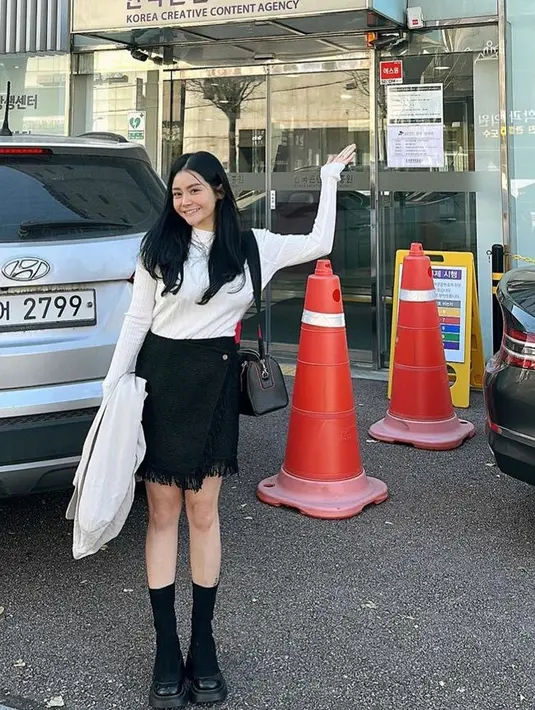 Berada di Korea, Mawar AFI memilih mengenakan atasan putih lengan panjang dipadukan mini skirt hitam. Sambil membawa sling bag hitamnya. [@MysaMawar]