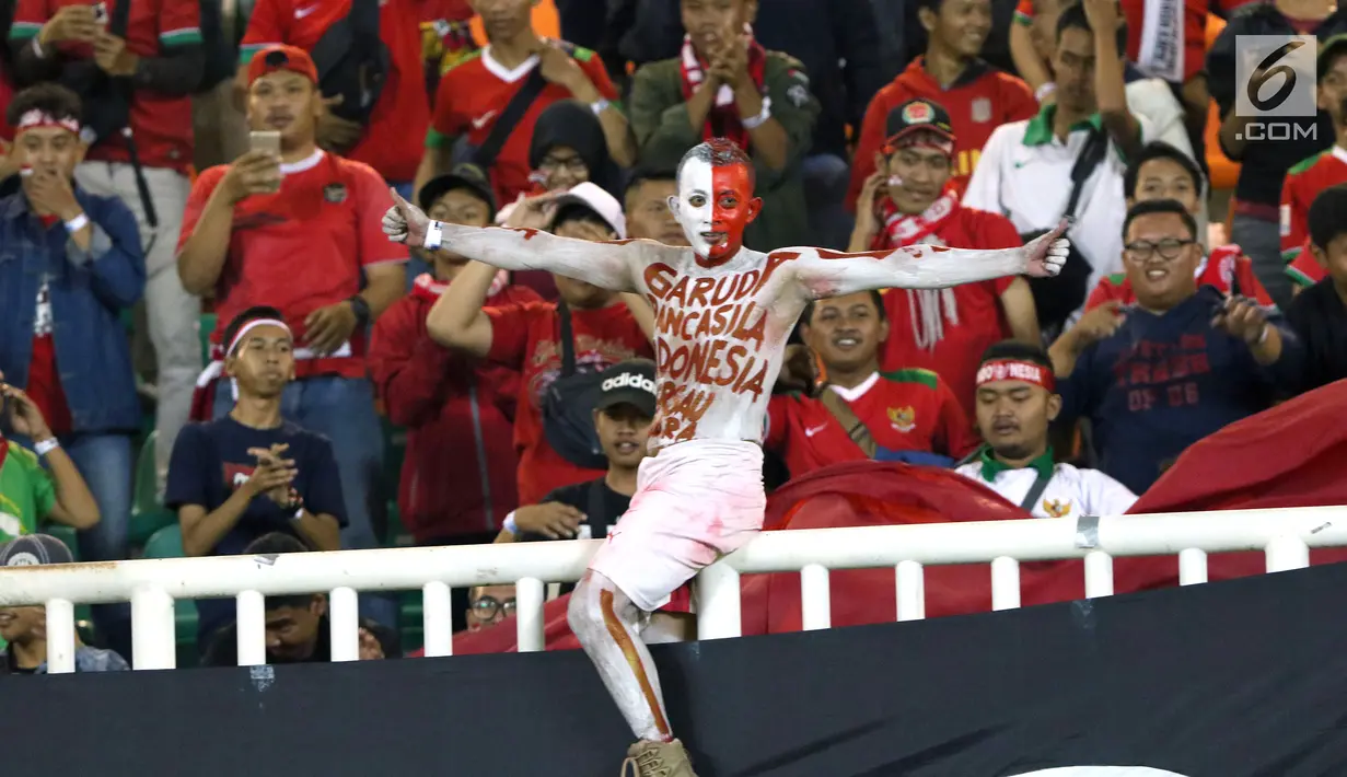 Suporter menyaksikan laga Indonesia U-19 melawan China U-19 pada PSSI 88th U-19 International Tournament di Stadion Pakansari, Selasa (25/9). Suporter membentangkan spanduk keprihatinan atas aksi kekerasan yang terjadi. (Liputan6.com/Helmi Fithriansyah)