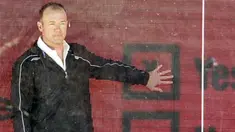 Former England and Newcastle footballer Alan Shearer stands in a glass advertising board in London, on February 27, 2008, offering fans around the world the chance to have their say about football. AFP PHOTO/SHAUN CURRY