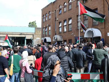 Orang-orang menghadiri upacara pengibaran bendera Palestina di luar Kedutaan Besar Palestina di London Barat, Inggris, pada 22 September 2025. (Adrian DENNIS/AFP)
