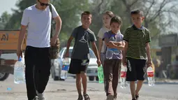 Selama sebulan terakhir, warga Bishkek, Kanychai Bakirova, tinggal bersama keluarganya yang terdiri dari 11 orang, termasuk anak-anak, di sebuah rumah yang hanya dialiri air dari keran. (VYACHESLAV OSELEDKO / AFP)