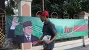 Warga berjalan melintasi spanduk bertuliskan 'Muhaimin for President' di pagar Masjid Sunda Kelapa, Jakarta, Sabtu (12/9). Pemasangan spanduk itu melanggar UU tentang larangan penggunaan tempat ibadah sebagai tempat kampanye. (Liputan6.com/Angga Yuniar)