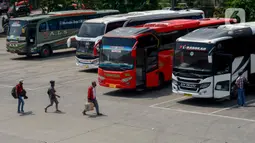 Sejumlah calon pemudik bersiap memasuki bus di Terminal Kampung Rambutan, Jakarta, Rabu (22/4/2020). Terminal Kampung Rambutan masih melayani penumpang menjelang pelarangan mudik Lebaran 2020 guna memutus mata rantai penyebaran COVID-19 pada Jumat 24 April mendatang. (merdeka.com/Imam Buhori)