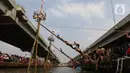 Lomba panjat pinang di atas aliran Kalimalang tersebut digelar dalam rangka merayakan hari ulang tahun (HUT) ke-78 Republik Indonesia. (Liputan6.com/Herman Zakharia)