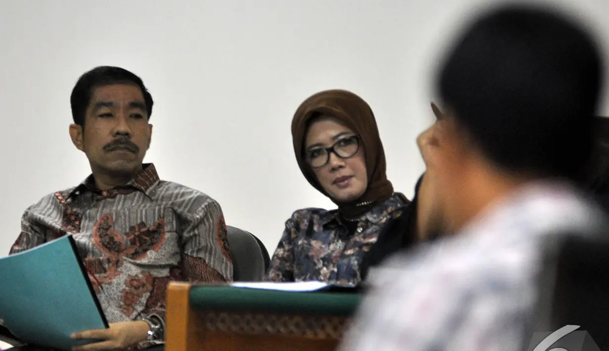 Romi Herton dan Istrinya Masyitoh memperhatikan keterangan saksi saat menjalani sidang lanjutan di Pengadilan Tipikor, Jakarta, Kamis (4/12/2014). (Liputan6.com/Miftahul Hayat)