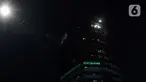 Aktivis Greenpeace menembakkan sinar laser bertuliskan Mosi Tidak Percaya ke gedung Merah Putih KPK, Jakarta, Senin (28/6/2021) malam. Aksi tersebut sebagai bentuk keprihatinan atas upaya pelemahan KPK sejak disahkannya Revisi UU KPK hingga Tes Wawasan Kebangsaan. (Liputan6.com/Helmi Fithriansyah)