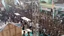Anggota Banser dan Pagar Nusa mengamankan bagian depan Gedung Serba Guna Ponpes Bahrul Ulum, Tambakberas, Jombang, yang digunakan sebagai ruang sidang pleno Muktamar ke-35 NU dengan agenda mekanisme pemilihan dan penentuan AHWA. (Liputan6.com/ Ahmad Apriyono)