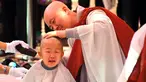 Seorang anak dicukur saat upacara berjudul 'Anak-anak Menjadi Buddha Monks', di kuil Jogye, Seoul, Rabu (19/4). Setelah upacara anak-anak akan tinggal di kuil selama dua minggu untuk mengikuti perayaan ulang tahun Buddha. (AFP PHOTO / JUNG Yeon-Je)