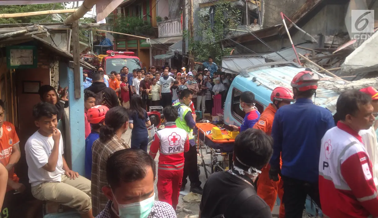 Petugas gabungan melakukan evakuasi korba rumah roboh di  Jalan Pulo, Tanah Tinggi, Johar Baru, Jakarta Pusa, Jumat (26/4). Hingga saat ini petugas masih melakukan evakuasi warga yang masih terjebak di dalam puing bangunan rumah yang ambruk. (merdeka.com/Imam Buhori)
