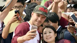 Eks pemain Arsenal, Lukas Podolski berselfie dengan penggemar saat upacara penyambutan di Kobe, Jepang barat, (6/7). Vissel Kobe kabarnya membayar €2,6 juta guna menebus Penyerang berusia 32 tahun ini. (Tsuyoshi Ueda/Kyodo News via AP)