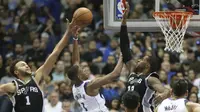 Aksi pemain Dallas Mavericks, Dennis Smith Jr. (1) mencoba mencetak poin saat diadang pemain San Antonio Spurs pada laga NBA Basketball game di American Airlines Center, Dallas, (14/11/2017). Spurs menang 97-91. (AP/LM Otero)
