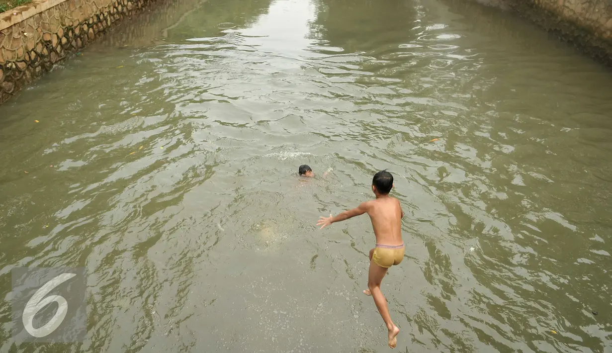 Kondisi air pada Anak Sungai Ciliwung di Jalan Labu, Kelurahan Mangga Besar sudah mulai membaik, Jakarta, Selasa (17/5). Meski belum terlalu bersih, seorang anak terlihat melompat untuk berenang di sungai tersebut. (Liputan6.com/Gempur M Surya)