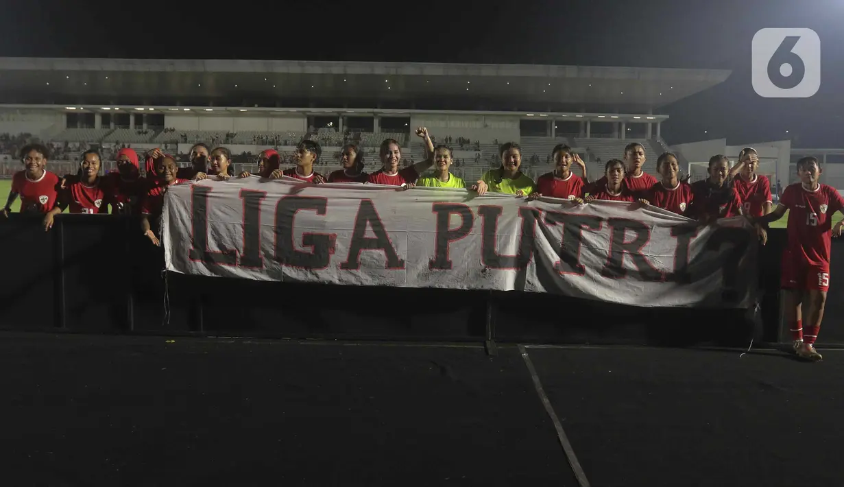 Para pemain timnas putri Indonesia membentangkan spanduk bertuliskan pertanyaan usai memetik kemenangan pada laga ujicoba internasional melawan Singapura. (Liputan6/Herman Zakharia)