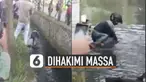 Diduga perampok, pria ini kecebur got dan dihakimi oleh massa.