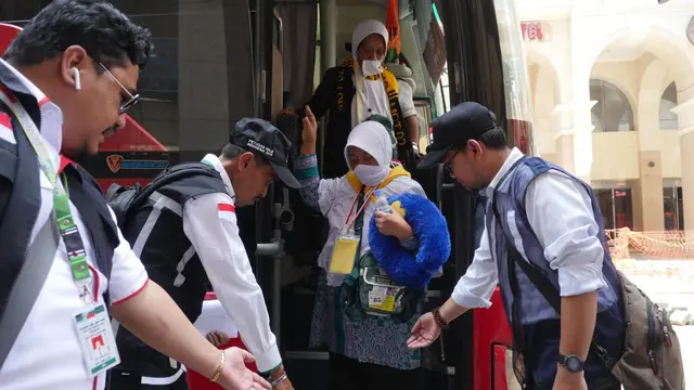 Petugas Jemaah haji membantu jemaah turun saat sampai di  hotel. Foto: Darmawan/MCH