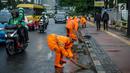 Petugas Dinas Kebersihan membersihkan genangan air usai hujan di kawasan jalan Sudirman, Jakarta, Rabu (22/11). Buruknya sistem drainase membuat petugas membersihkan genangan setiap kali hujan, meski dengan peralatan seadanya. (Liputan6.com/Faizal Fanani)