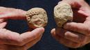 Seorang arkeolog menunjukkan pecahan keramik berupa stempel bertuliskan huruf Ibrani kuno yang ditemukan di sebuah situs penggalian di Yerusalem (22/7/2020). Tim arkeolog Israel menemukan pusat penyimpanan administratif berusia 2.700 tahun di Yerusalem. (Xinhua/Gil Cohen Magen)
