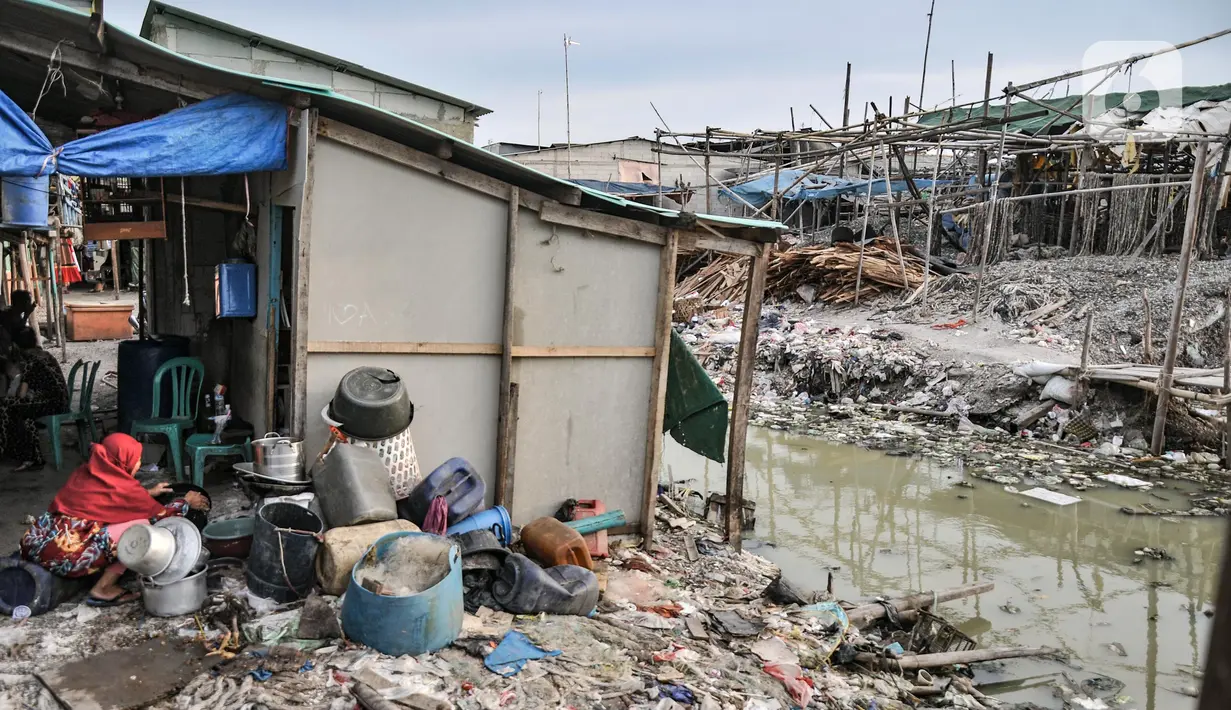 Warga saat mencuci piring di kampung nelayan Kalibaru, Cilincing, Jakarta Utara, Selasa (22/3/2022). Sementara untuk kebutuhan MCK, warga tetap menggunakan air sumur yang diendapkan terlebih dahulu. (merdeka.com/Iqbal S Nugroho)