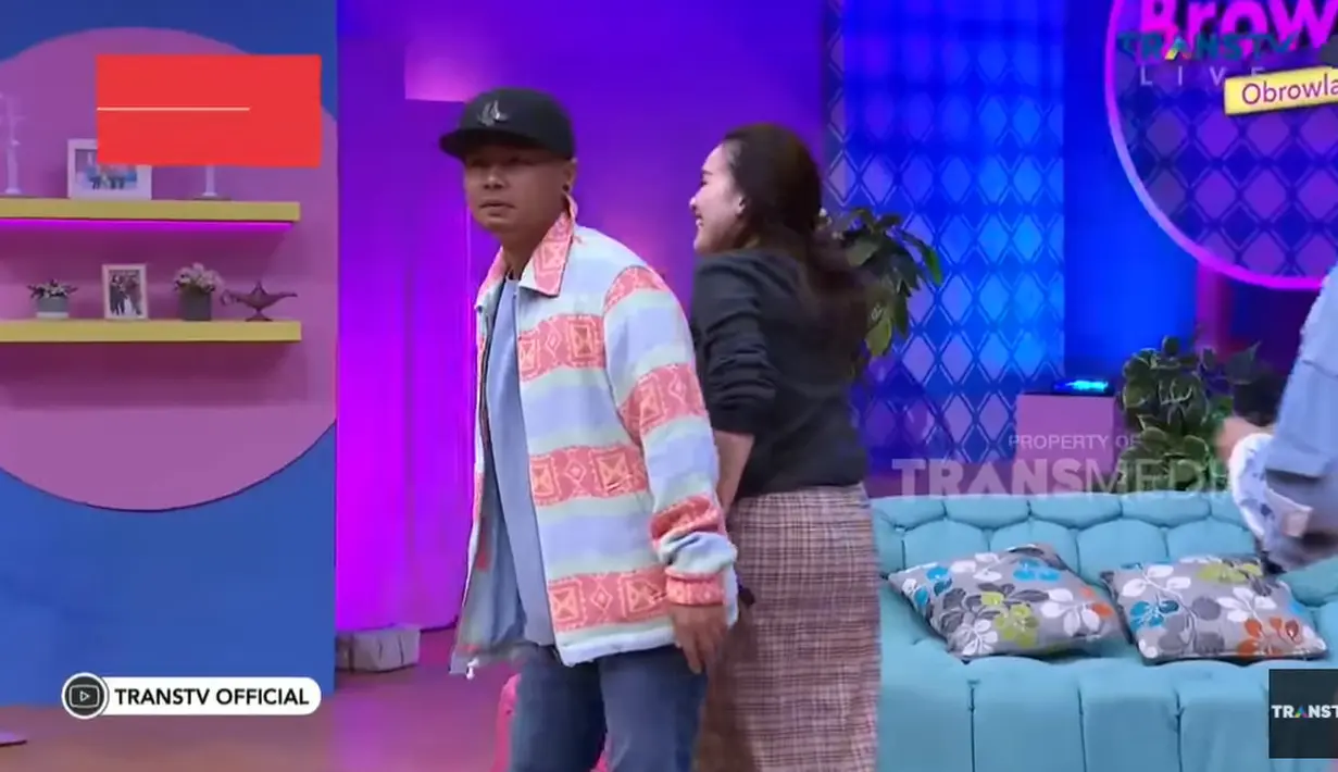 Wendy Cagur berusaha menutupi bagian rok Ayu Ting Ting yang sobek dengan badannya agar tak tersorot kamera. (Foto: YouTube/ Trans TV Official)
