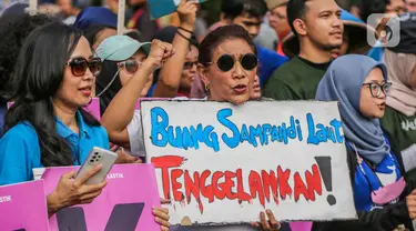 Mantan Menteri Kelautan dan Perikanan Susi Pudjiastuti membawa poster saat mengikuti pawai bebas plastik di kawasan Sudirman, Jakarta, Minggu (30/7/2023). (Liputan6.com/Faizal Fanani)