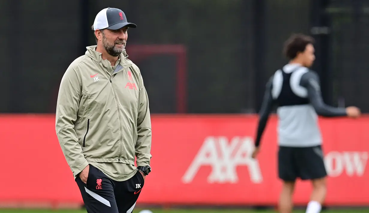 Pelatih Liverpool, Jurgen Klopp menyaksikan pemainnya mengikuti sesi latihan di pusat pelatihan Axa di Kirkby, Liverpool, Inggris (14/9/2021). Liverpool akan bertanding melawan wakil Italia, AC Milan pada Grup B Liga Champions di Anfield. (AFP/Paul Ellis)