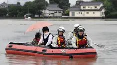 Warga dievakuasi menggunakan perahu karet saat banjir merendam daerah Asakura di prefektur Fukuoka, Kamis (6/7). Hujan lebat yang disebabkan angin topan di selatan Jepang telah memaksa evakuasi hampir 400.000 orang. (Sadayuki Goto/Kyodo News via AP)