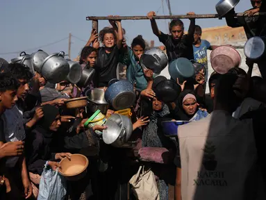 Warga Palestina menunggu bantuan gula dan beras di dapur umum di Khan Younis, Jalur Gaza selatan, Jumat, 31 Oktober 2025. Di tengah berlangsungnya kesepakatan gencatan senjata antara Israel dan Hamas, warga Palestina di Khan Younis, Jalur Gaza selatan, masih menghadapi kesulitan dalam mendapatkan bantuan pangan, termasuk gula dan beras. (AP Photo/Abdel Kareem Hana)