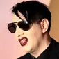 Rocker, Marilyn Manson berpose saat menghidiri di Fashion Awards 2016 di London, Inggris (5/12). Mengenakan Jas dan kacamata hitam Marilyn Manson tampil keren saat menghadiri acara tersebut. (REUTERS/Neil Balai)