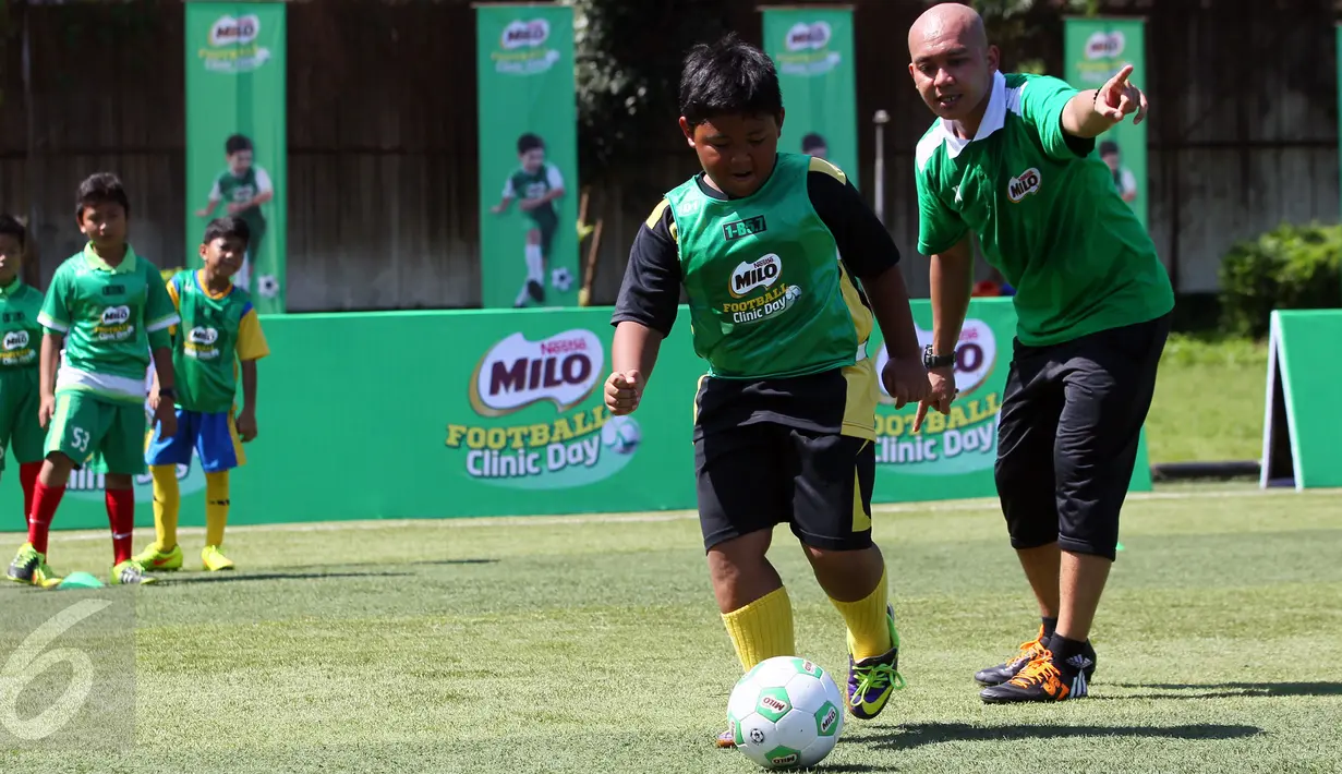 Pelatih sepak bola U-12 Zaenal Abidin sedang memberikan arahan mengenai cara menggiring bola kapada peserta MILO Football Clinic Day di Lapangan Sepakbola Pertamina-Simprug, Jakarta (29/10). (Liputan6.com/Istimewa)