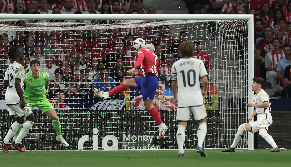 Pemain Atletico Madrid, Antoine Griezmann (tengah), mencetak gol kedua ke gawang Real Madrid dalam pertandingan pekan keenam La Liga Spanyol 2023/2024 yang berlangsung di Metropolitano stadium, Madrid, Senin (25/9/2023). Gol kedua Atletico Madrid tercipta berkat kerjasama apik antara Samuel Lino dan Saul Niguez. (AFP/Thomas Coex)