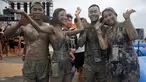 Wisatawan bermain di kolam lumpur selama Boryeong Mud Festival atau Festival Lumpur Boryeong di pantai Daecheon, Korea Selatan, Sabtu (20/7/2019).  Ajang mandi lumpur sepuasnya di Korea Selatan ini, merupakan festival khusus untuk memeriahkan musim panas di negeri ginseng. (Minji SUH/AFP)